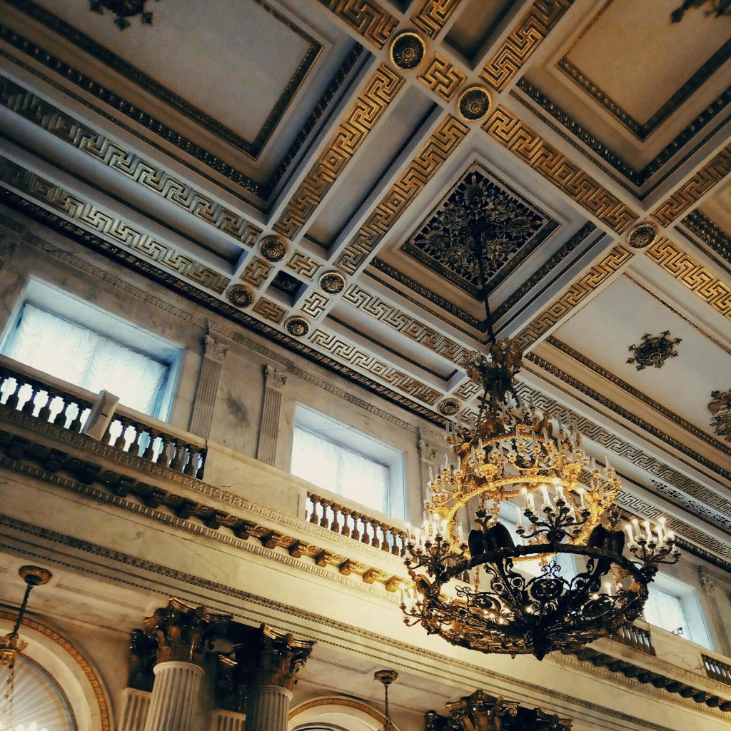 A balcony, and chandelier on the ceiling of The State Hermitage Museum