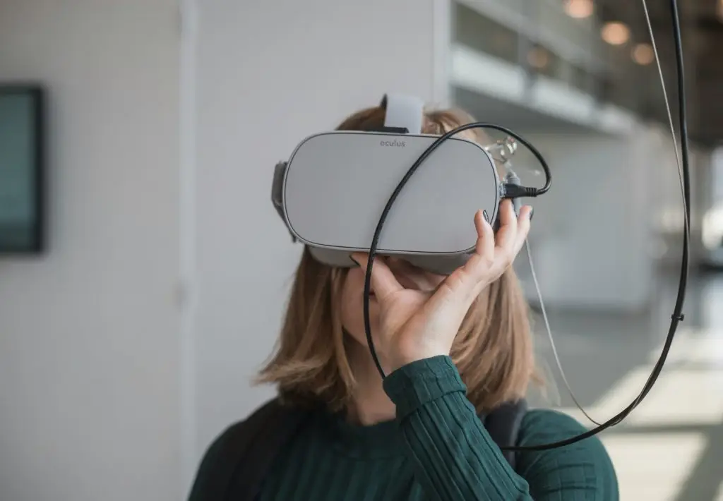 A woman wearing a vr headset, to visit Virtual Exhibition Halls