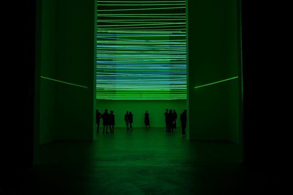 Photo of person starring at lights during Documenta exhibition.