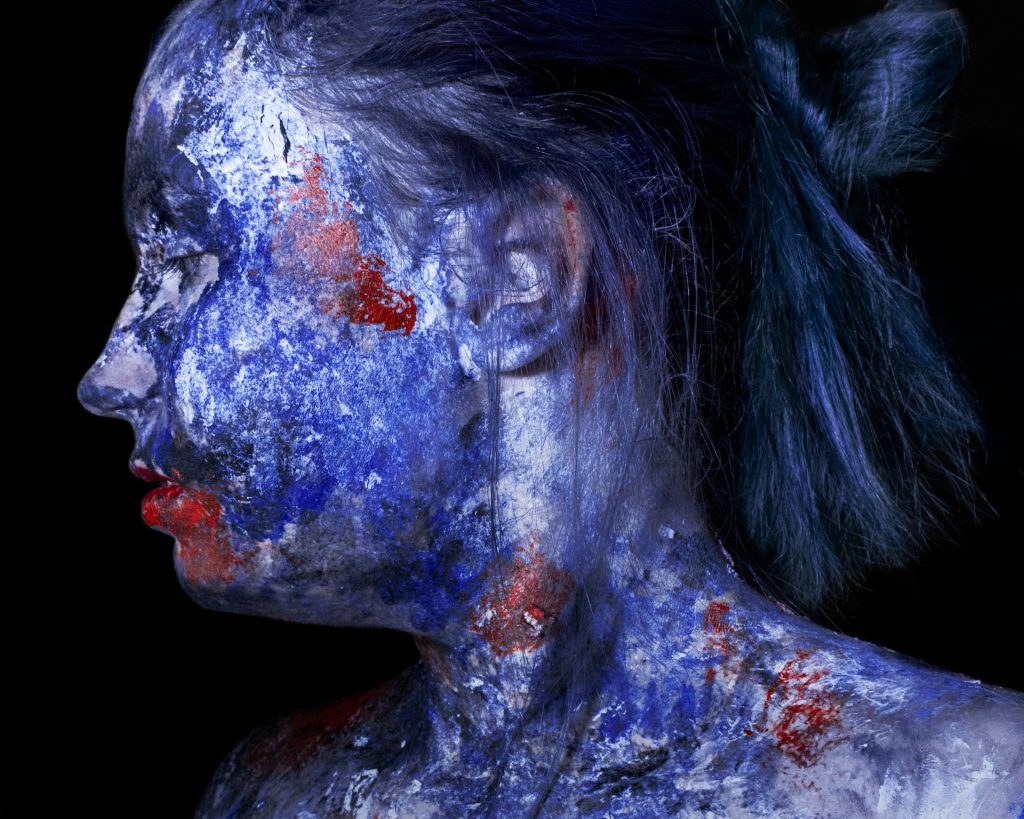 A girl with face-and body paint, demonstrating the non-traditional nature of avant-garde