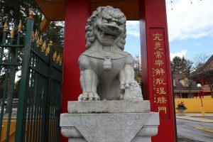 A chinese lion statues at a gate