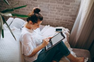 A woman sketching on a drawing tablet