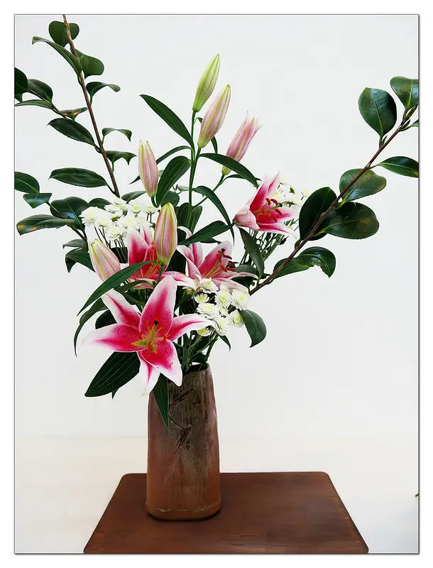 An ikebana work with leaves and flowers
