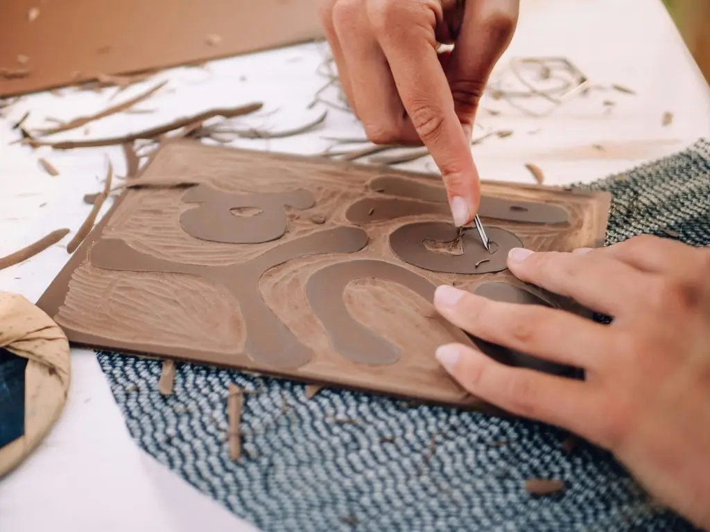 A person cutting into linoleum
