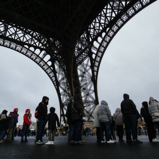 Visitors queue under the Eiffel Tower to enter, on the day of its reopening after a strike, in Paris on February 25, 2024. The Eiffel Tower, closed for five days due to a strike, reopens on February 25, 2024 following an agreement between the unions and the Paris monument's operating company, the latter announced on Saturday. (Photo by Dimitar DILKOFF / AFP) (Photo by DIMITAR DILKOFF/AFP via Getty Images)