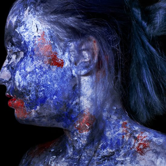 A girl with face-and body paint, demonstrating the non-traditional nature of avant-garde