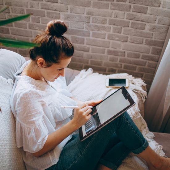 A woman sketching on a drawing tablet